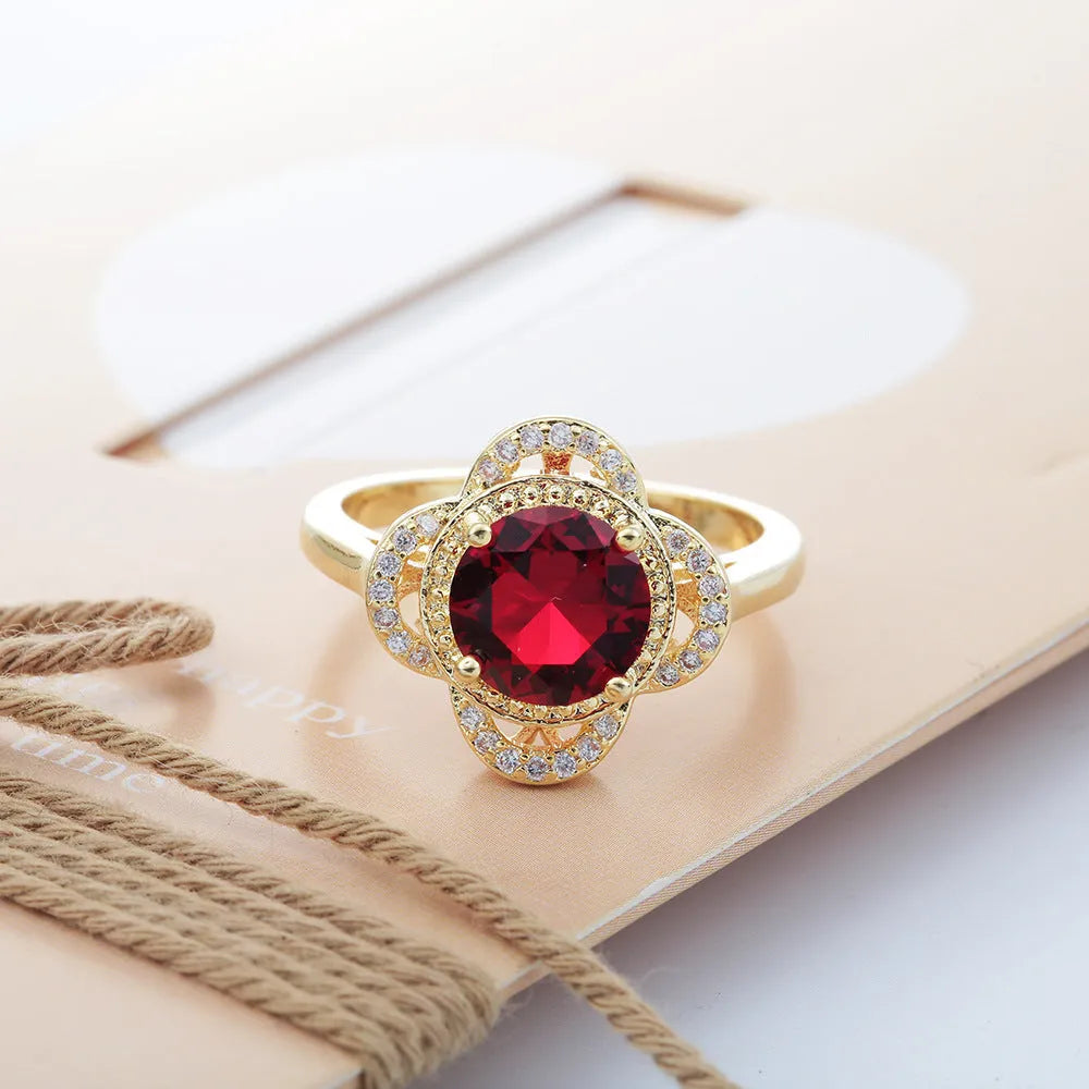 Copper ring with fruit shape and inlaid zircon details on a finger.