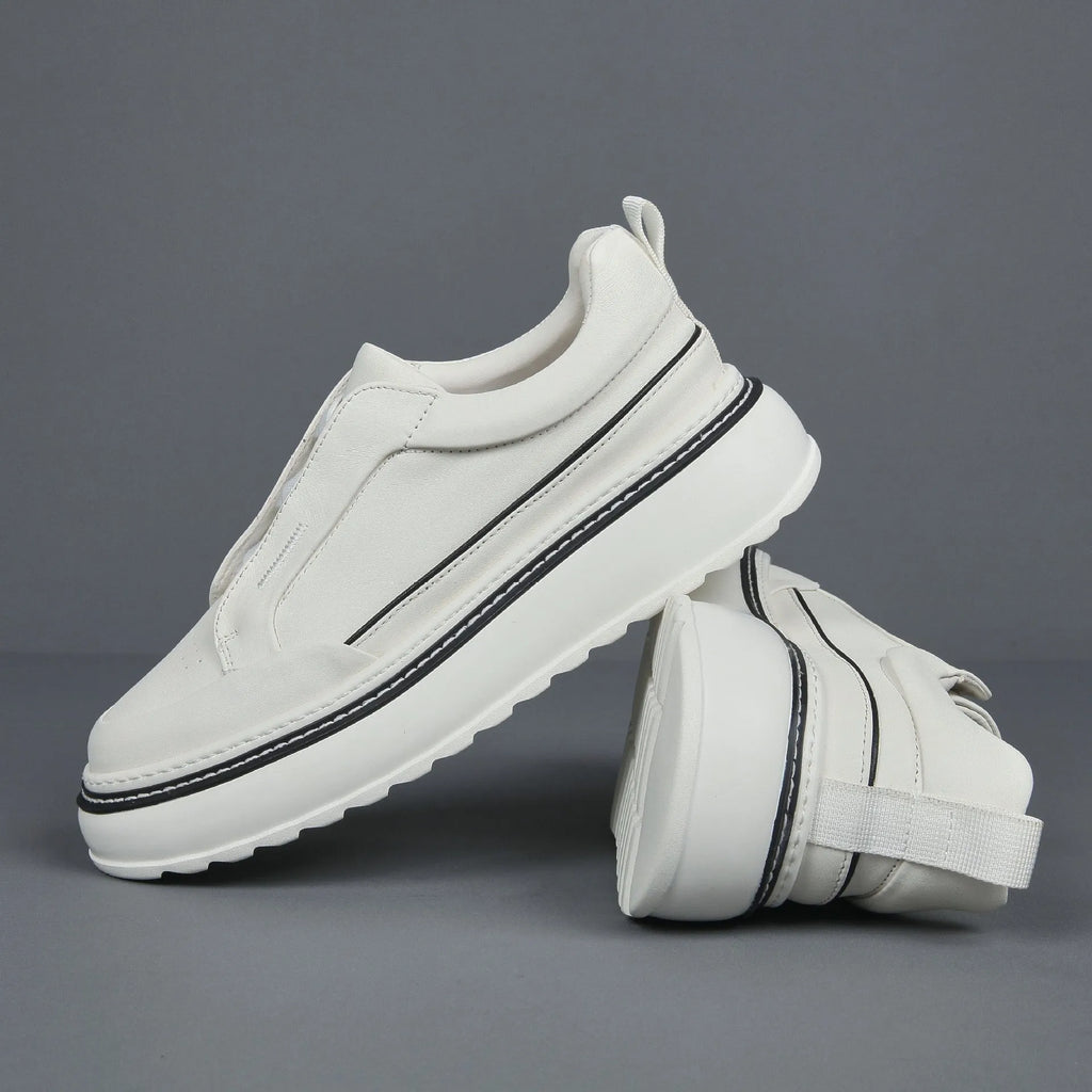 Black leather low-top slip-on sneaker with elastic sides and foam sole on white background
