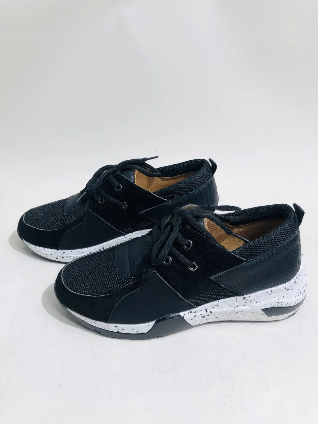 Women's black suede casual sneakers with a wedge heel on a white background