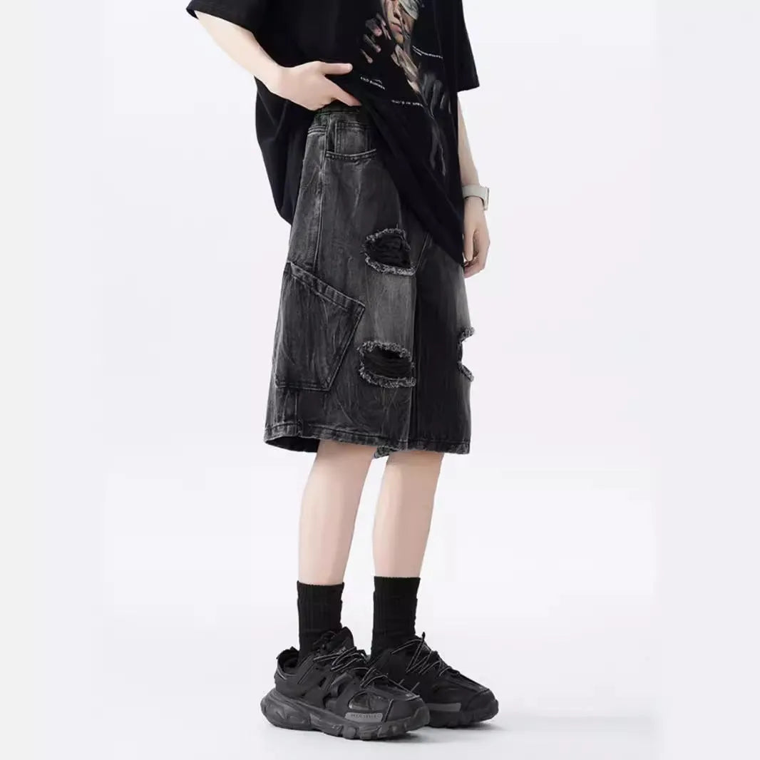 Men's loose-fit washed ripped denim shorts in black and blue colours with distressed detailing and retro styling