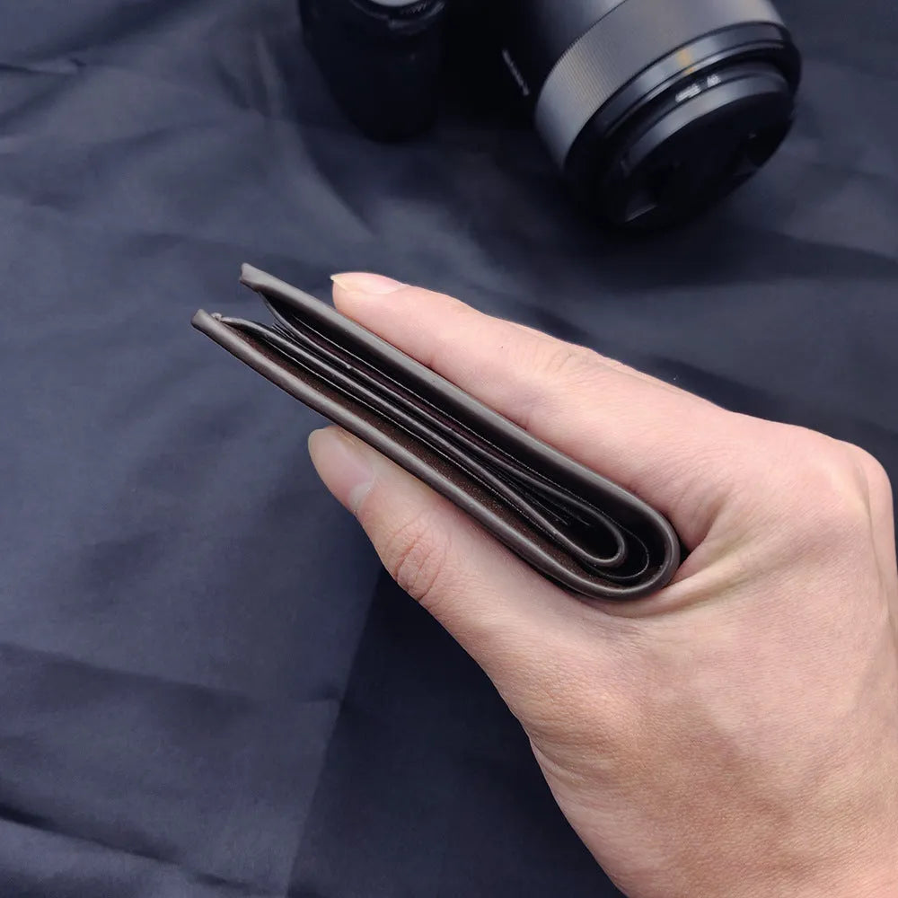Men's brown leather wallet with a silver zipper fastening, shown open to reveal multiple card slots.