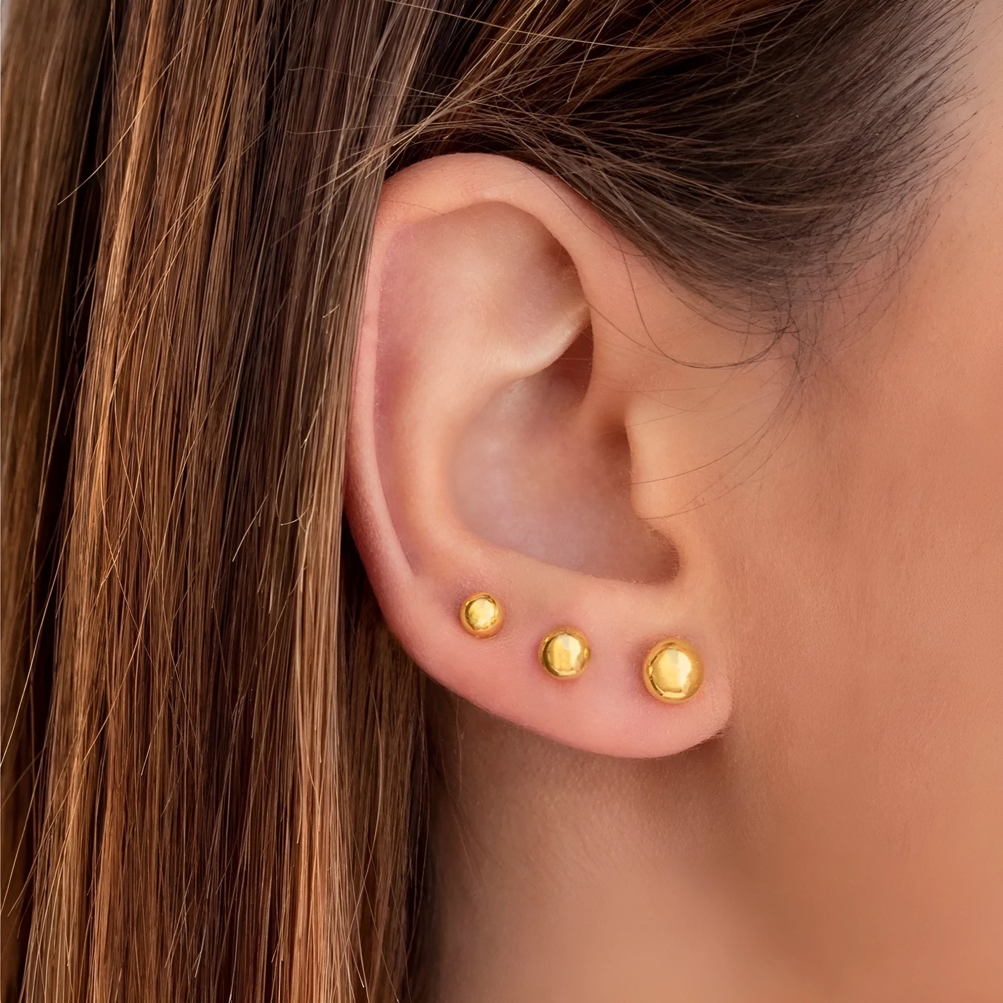 Stainless steel ball stud earrings in gold and silver colours showing 3mm to 6mm size range