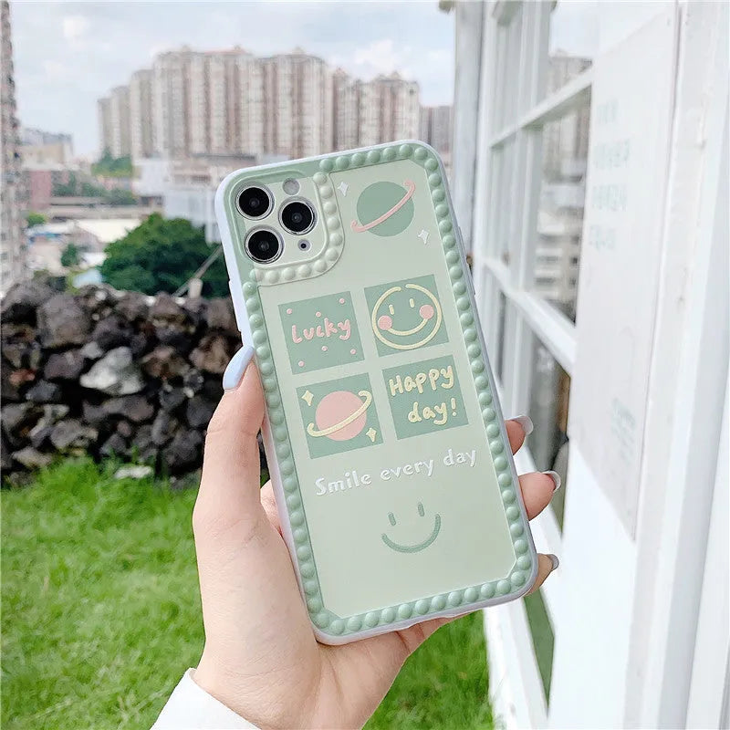Green TPU iPhone case with polka dot frame and colourful smiley face geometry patterns