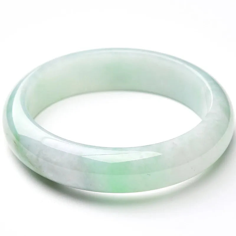 Light green jade bracelet showing natural stone texture with sizing chart displaying 53mm to 64mm circumference options