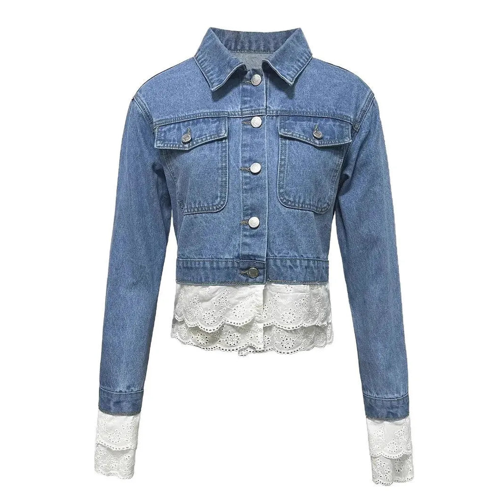 Blue denim jacket for women with lace stitching on the sleeves and front, shown on a hanger.