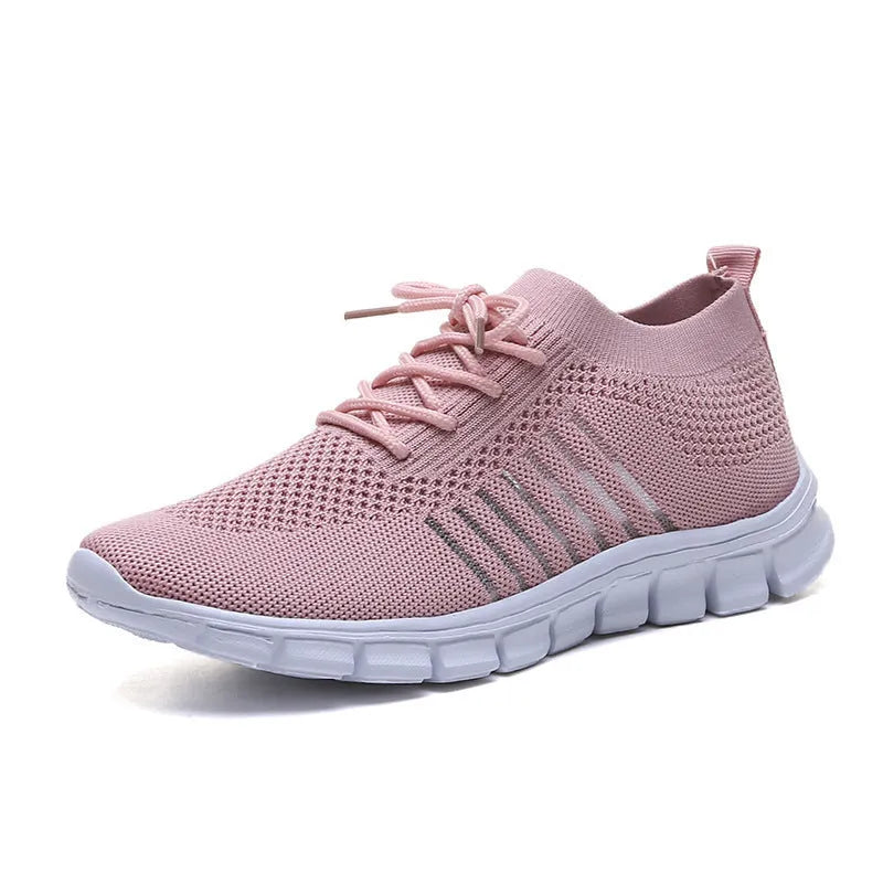 Women's casual breathable mesh flat shoes in pink with front tie and low heel on a light background.