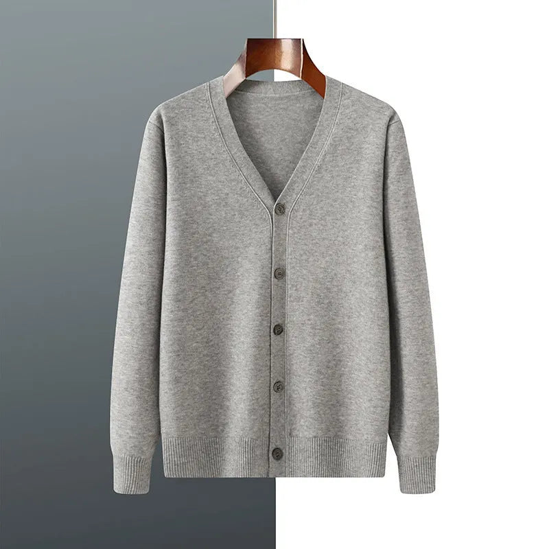 Man wearing a loose V-neck cardigan coat in Andy Velvet fabric, showing the long sleeves and available colour options.