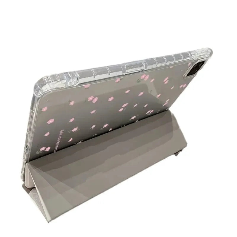 Transparent tri-fold iPad case with floral cartoon pattern, shown in standing position with magnetic closure