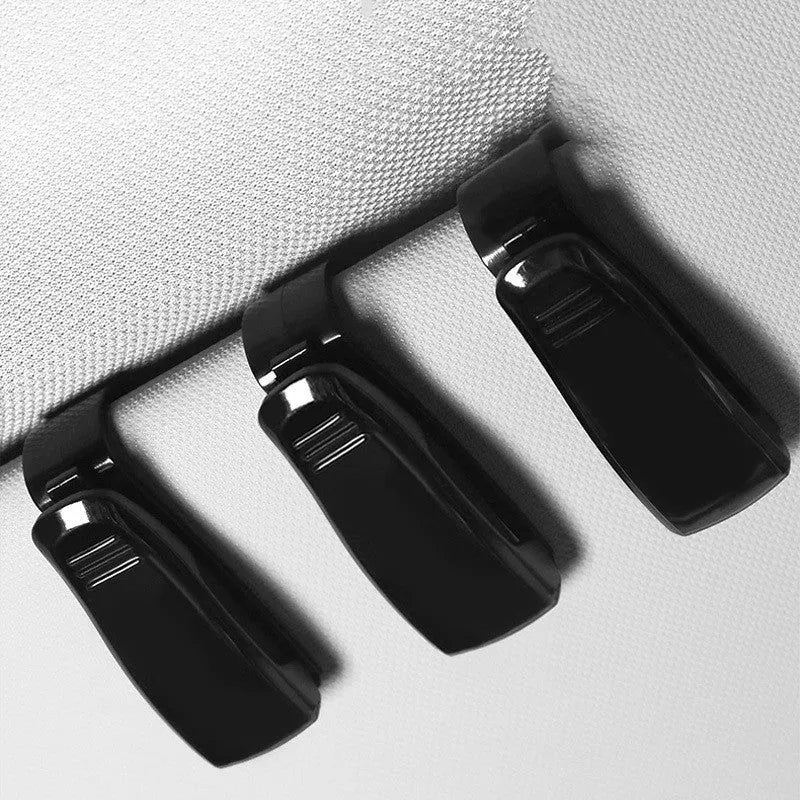 Black plastic clip holder for car sunshade to hold glasses, ID cards, and tickets.