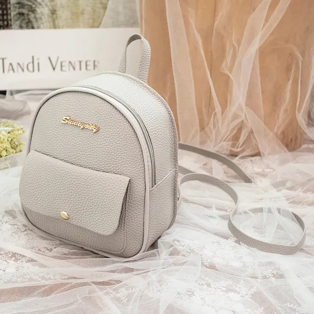 Solid colour PU leather women's small shoulder backpack with zipper, shown in available colours.