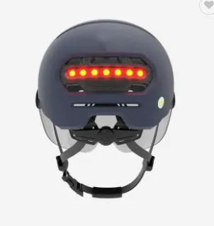 Cycling helmet with integrated red LED brake light on the back, shown in sizes M and L.