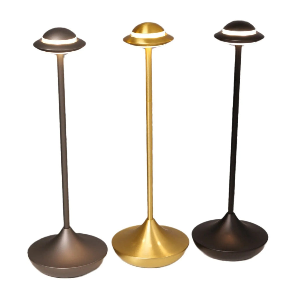 Metallic UFO-shaped desk lamp with touch controls in black finish on wooden surface