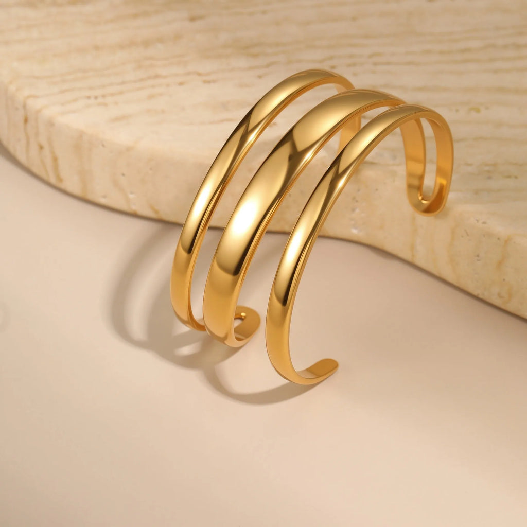 Stainless steel women's bracelet with simple opening clasp and geometric line design in gold electroplated finish