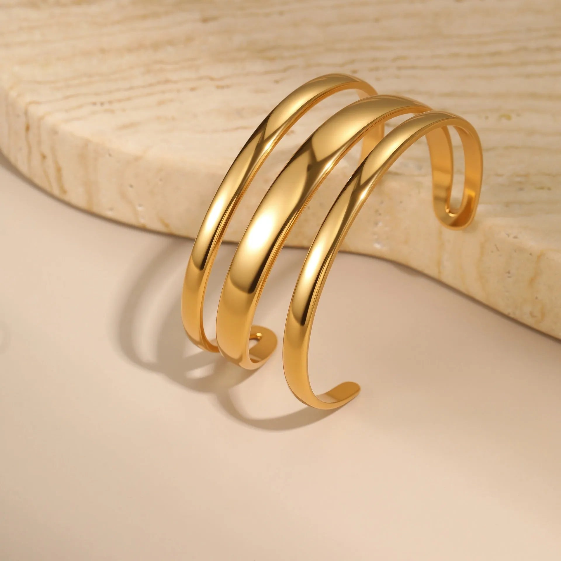 Stainless steel women's bracelet with simple opening clasp and geometric line design in gold electroplated finish