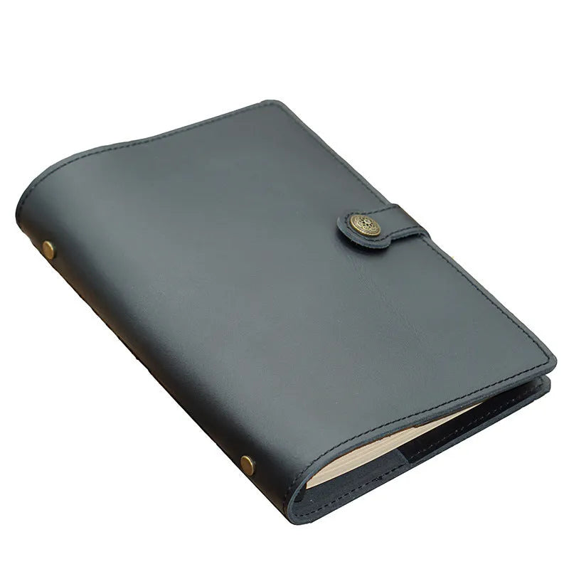 A5 handmade cowhide notebook with genuine leather cover in Crazy Horse Brown, opened on a table