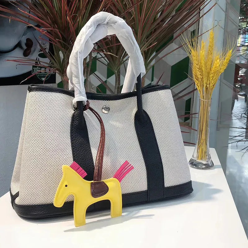 Genuine leather crossbody bucket tote bag with canvas surface in multiple colour options
