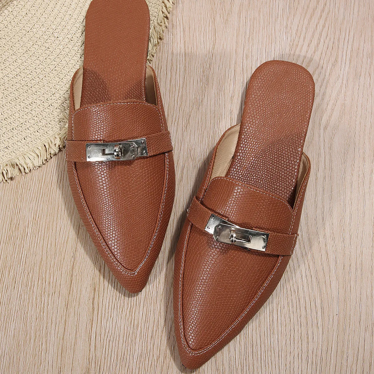 Light brown women's pointed-toe casual slippers with a low heel and rubber sole.