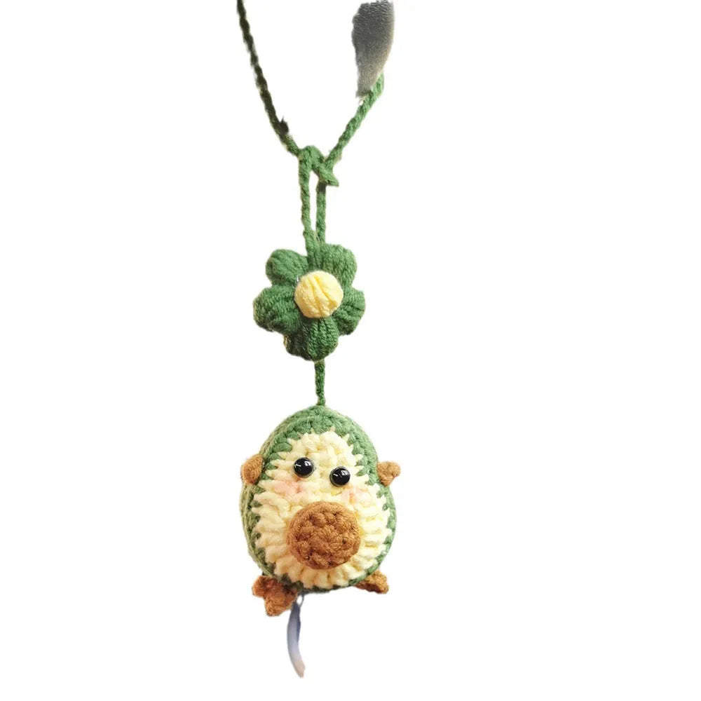 Handmade crocheted avocado-shaped rainbow flower car pendant hanging, shown in multiple colour options.