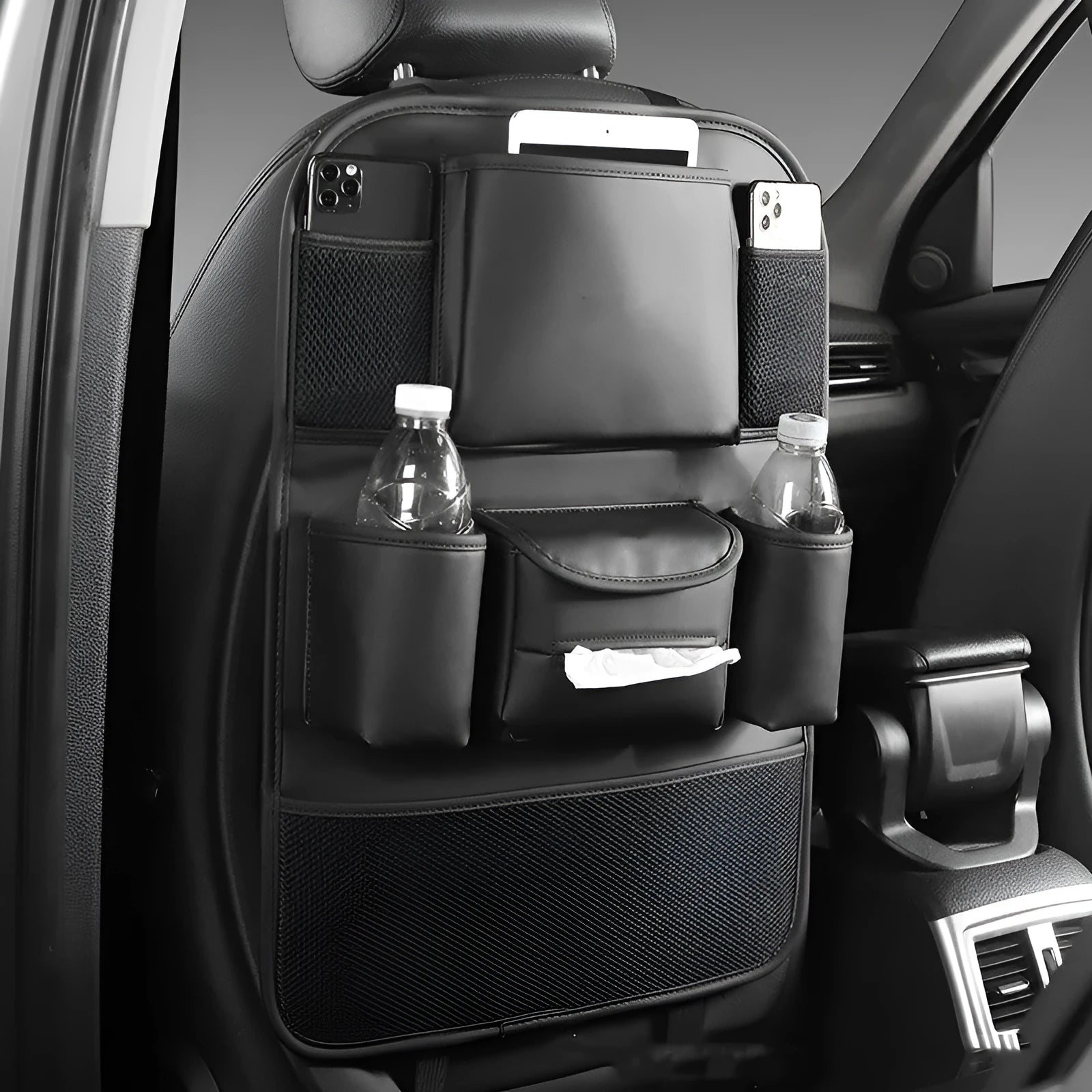 Genuine leather car seat back storage bag shown in grey, suspended behind a car headrest.