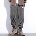 Men's grey ankle-tied straight leg sweatpants with elastic waist on a white background.