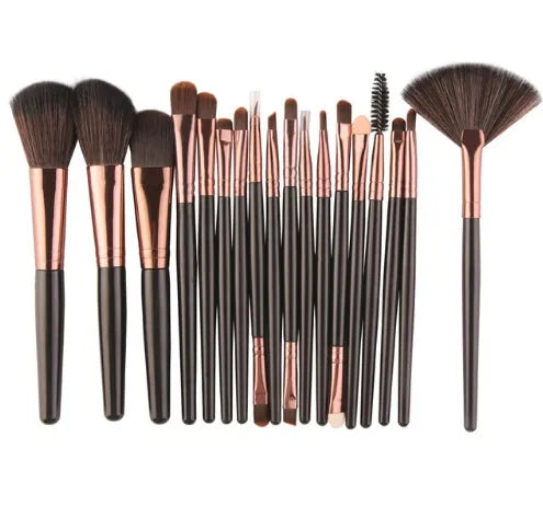 MAANGE 18-piece makeup brush set with fan-shaped cosmetic tools laid out on a table.