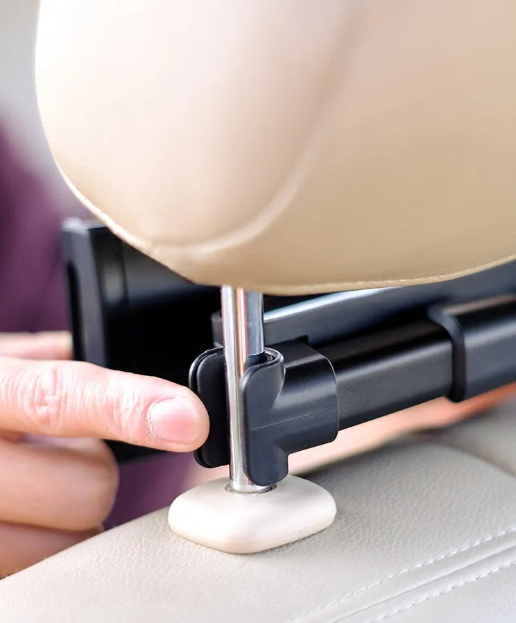 Black car phone holder mounted on rear seat headrest with tablet securely positioned