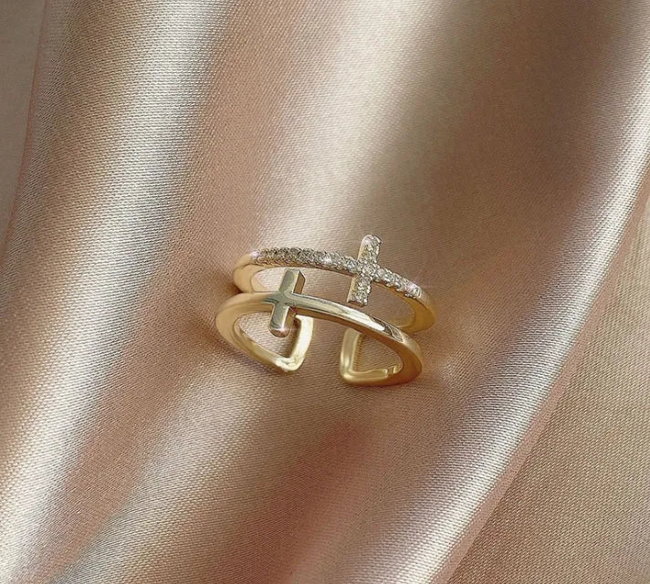 Adjustable double cross geometric ring made of copper with white gold finish and inlaid zircon stones.