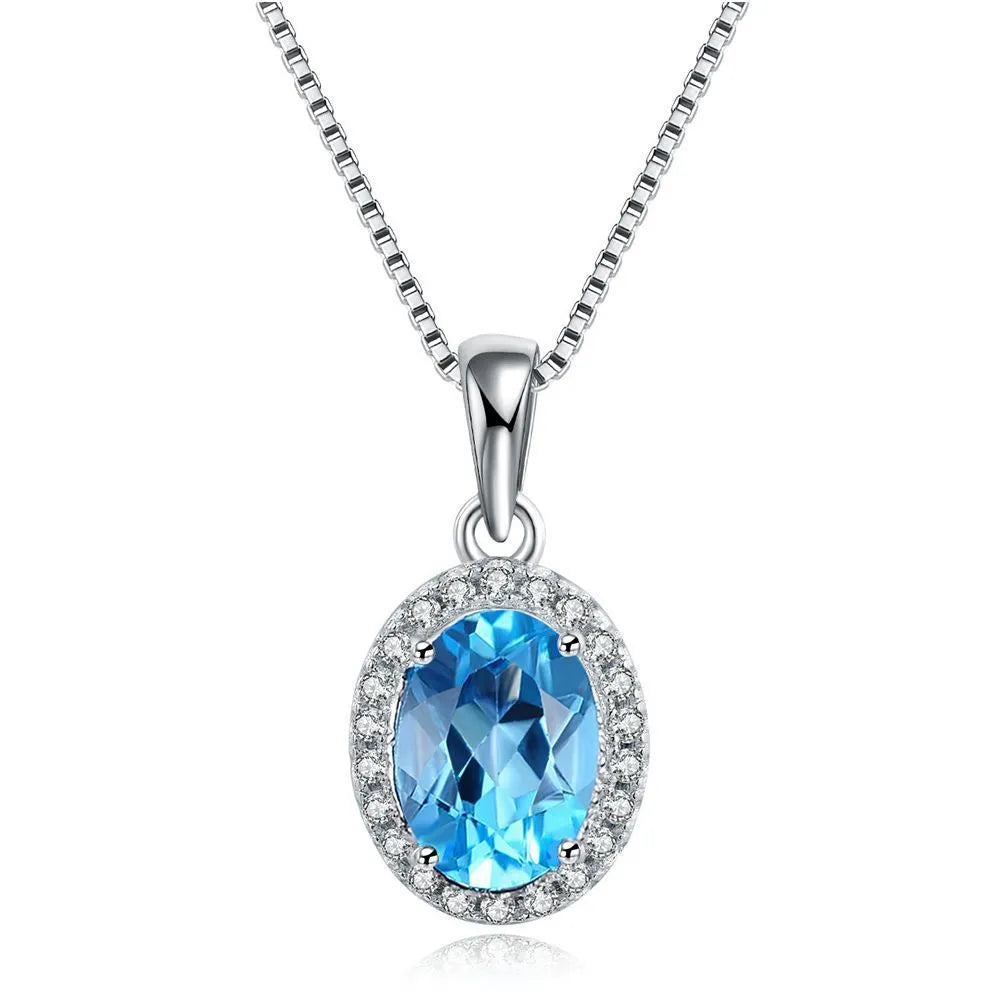 Four-piece 925 sterling silver jewellery set with blue topaz stones: geometric necklace, earrings, ring, and pendant.