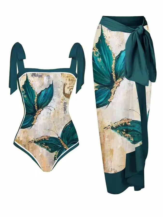 Women's floral print two-piece swimsuit with a blue chiffon skirt laid flat.