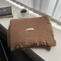 Four-layer gauze cotton blanket with tassel trim in navy blue colour