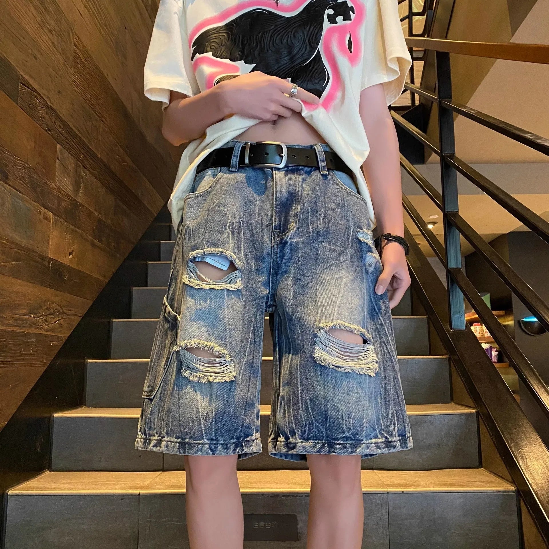 Man wearing black retro five-point cotton denim breeches with a casual shirt.