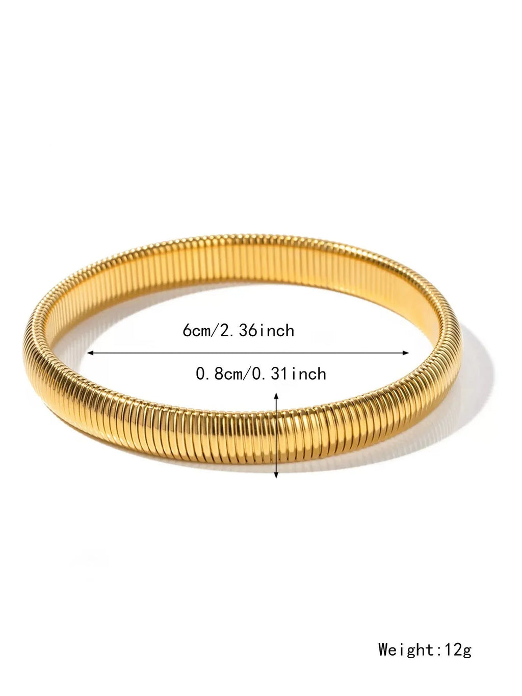 Close-up of a women's titanium steel bracelet with a vertical stripe ring pattern, shown in a gold tone finish on a wrist.