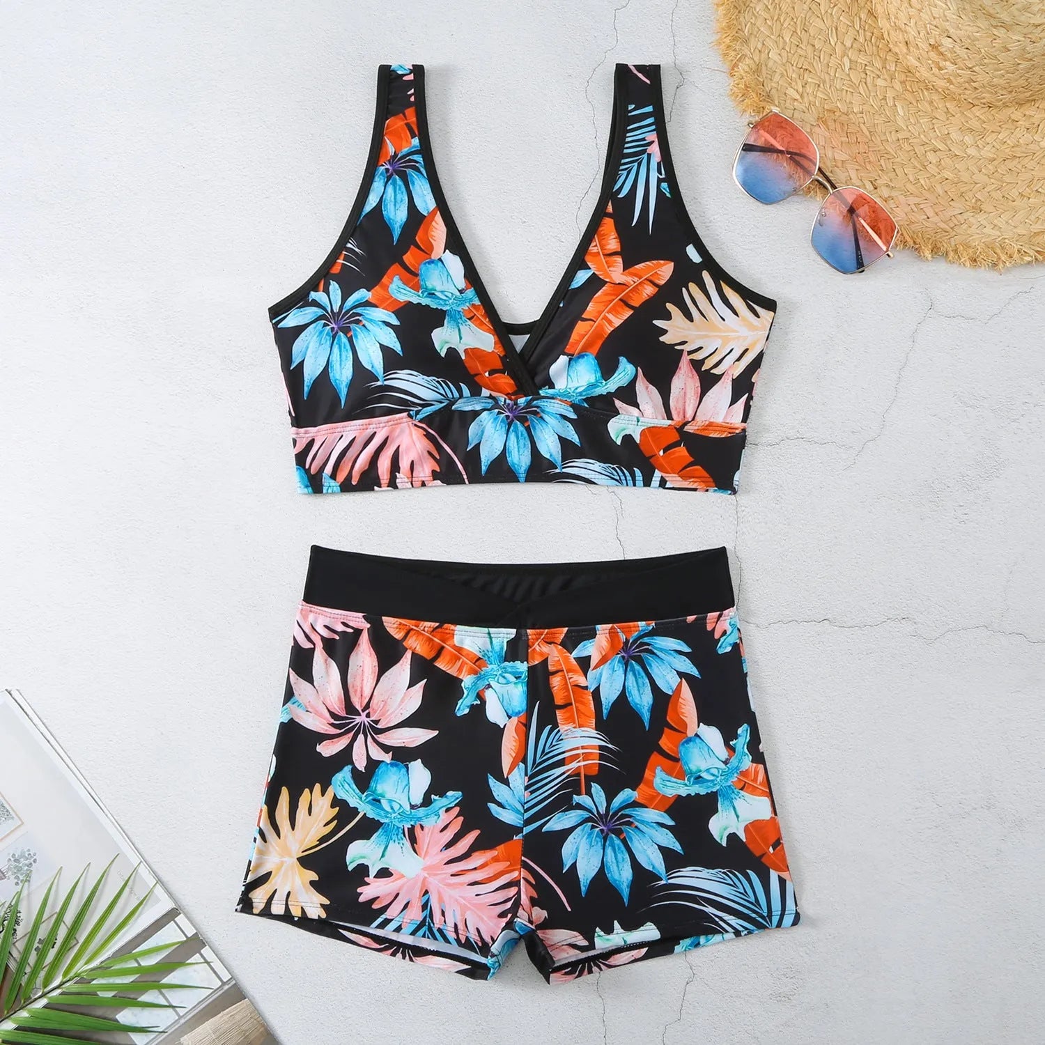 Women's two-piece printed swimsuit set with sleeveless top and boxer shorts in a multi-colour design.