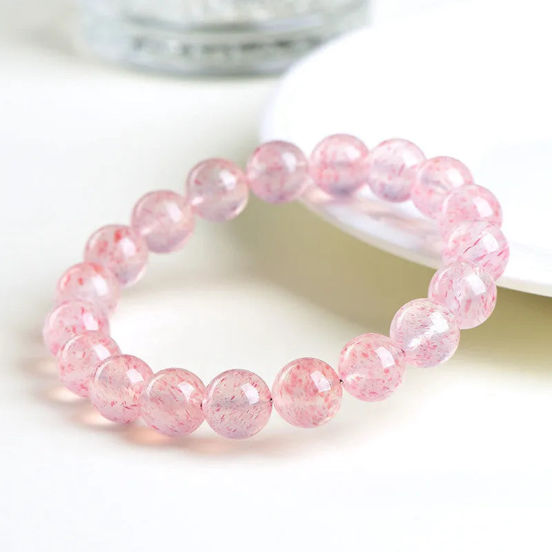 Strawberry quartz crystal bracelet with spherical 10-10.8mm beads in white water colour