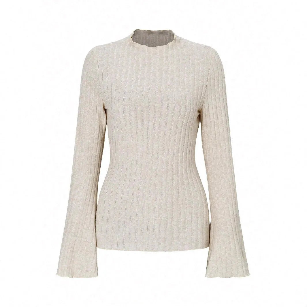 Man wearing a black long sleeve top with a subtle sunken stripe pattern and lantern sleeves.