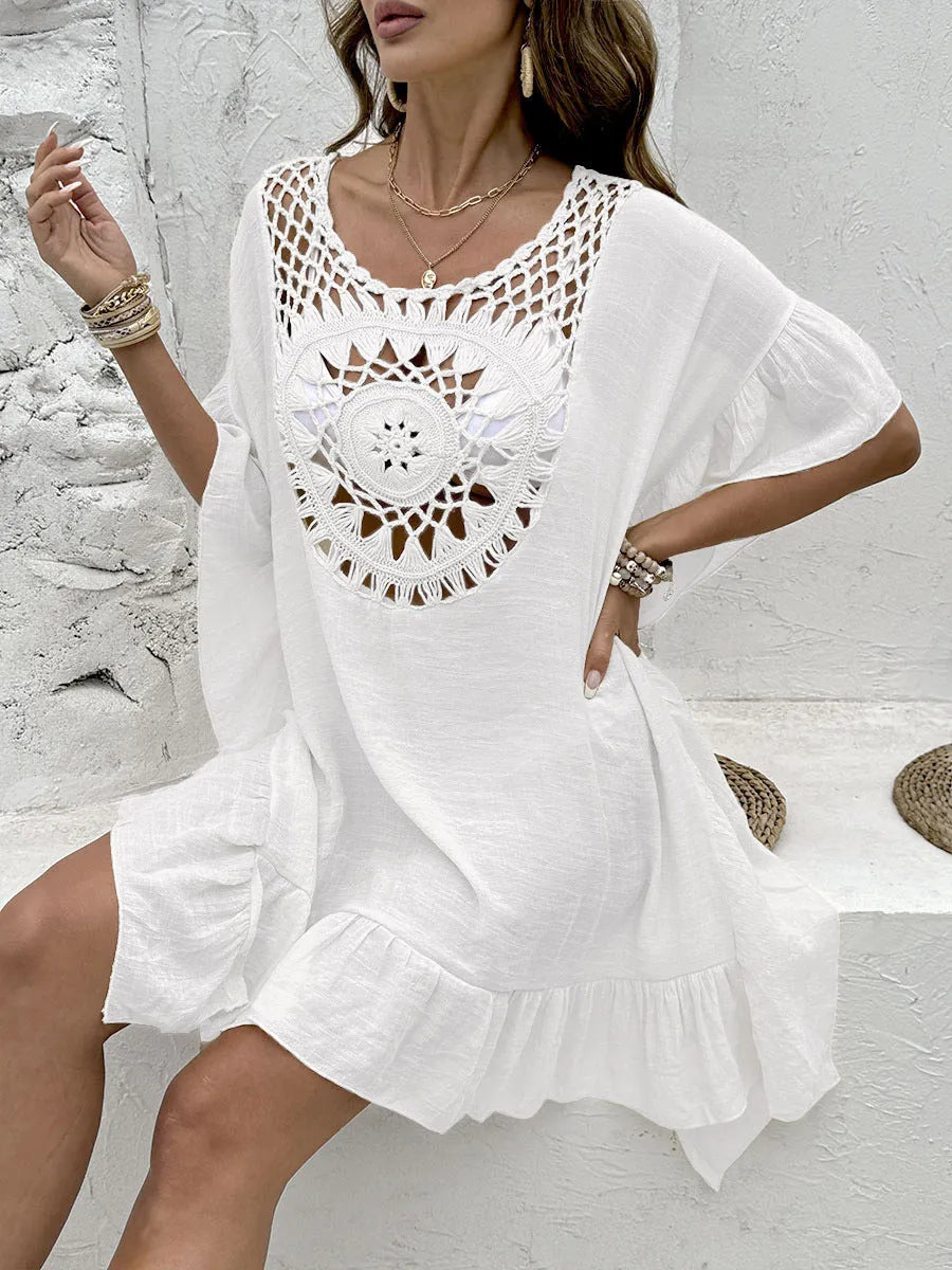 Crochet tassel detail on a patchwork skirt-style beach cover-up dress in apricot colour.