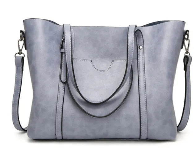 Retro messenger bag for women in multiple colours showing large main compartment and shoulder strap