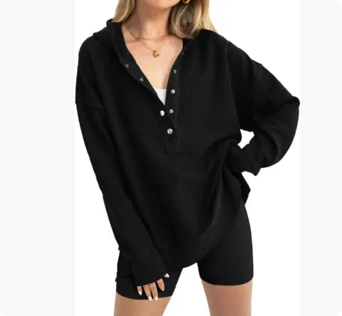 Women's loose peacock green raglan sleeve pullover sweater on a hanger.