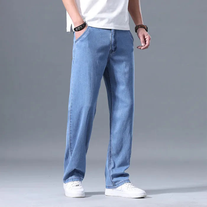 Man wearing light blue loose straight-leg lyocell blend casual jeans.