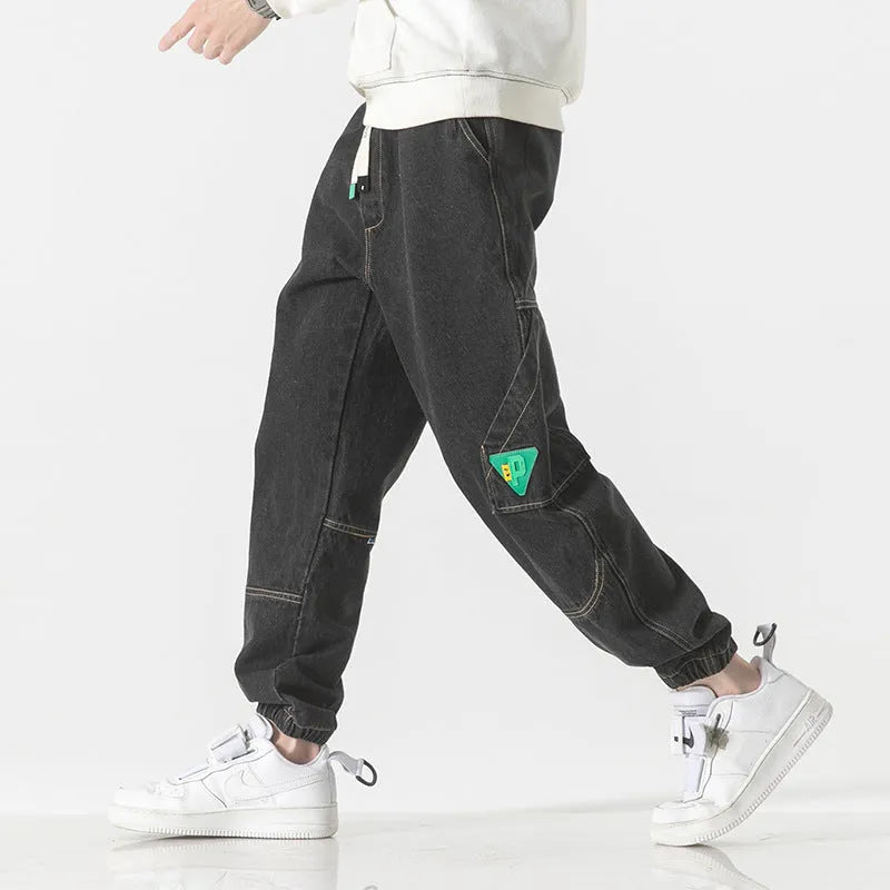 Men's loose-fit tapered cotton trousers in black, blue and grey colours showing mid-waist design