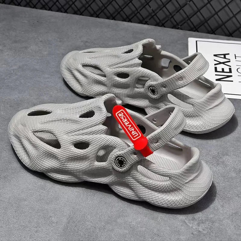 Pair of gray closed-toe EVA coconut slippers with a textured frosted finish and perforated upper.