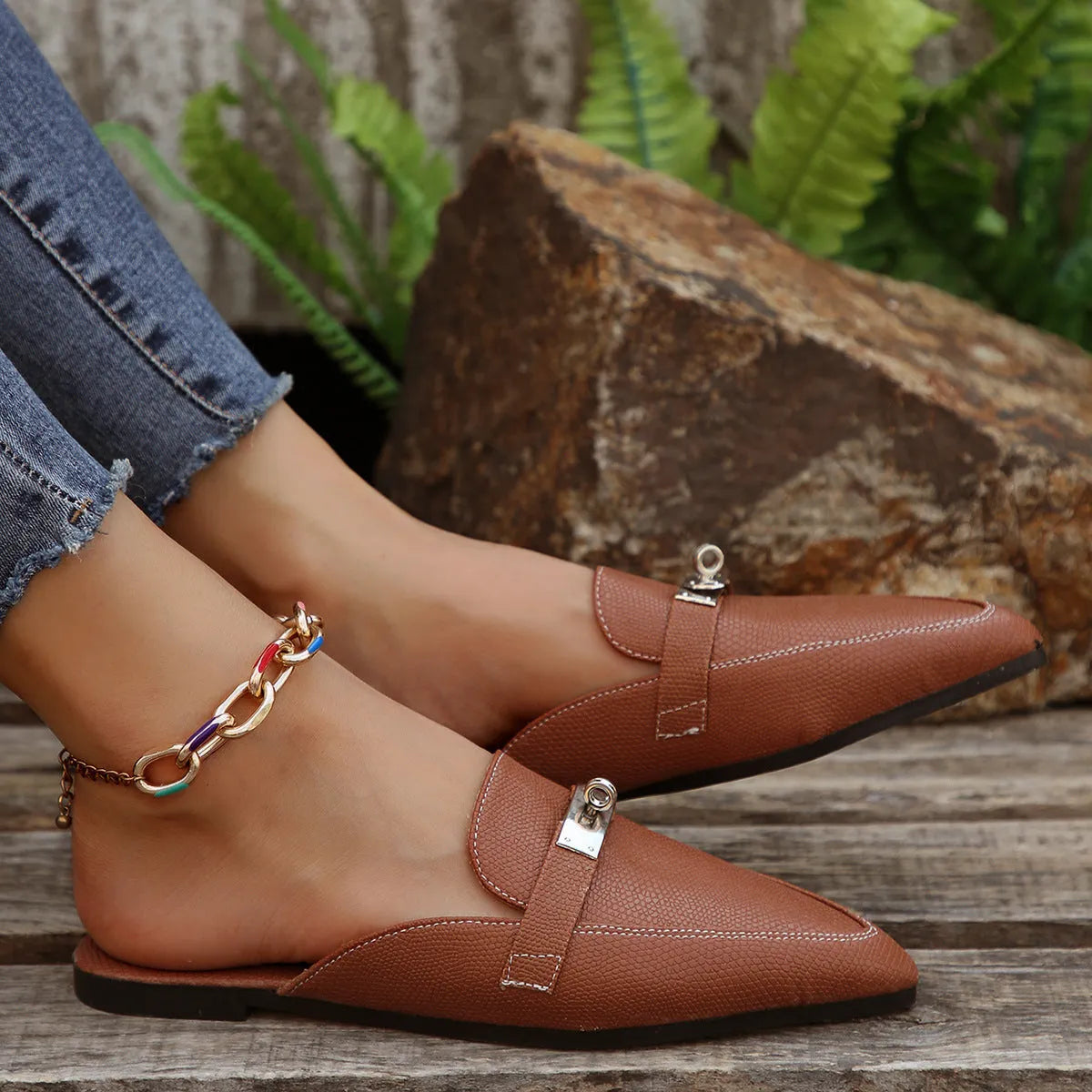 Light brown women's pointed-toe casual slippers with a low heel and rubber sole.