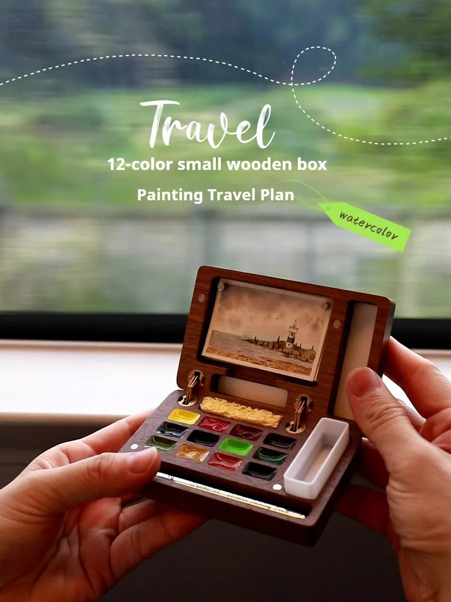 Mini walnut wood watercolour paint box open to show pigment pans with leather carrying bag