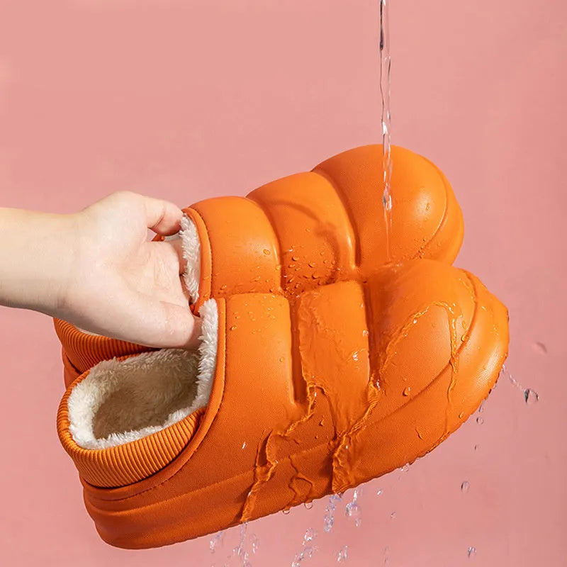 Green EVA waterproof garden slippers with non-slip sole and plush lining shown on wooden decking