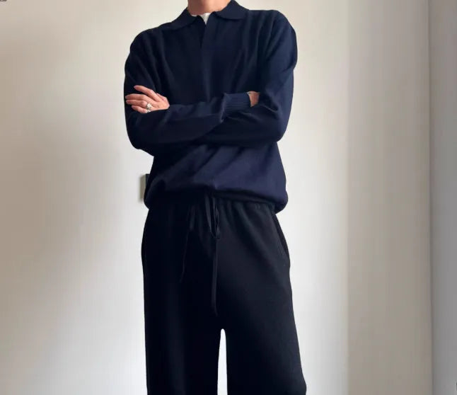 Man wearing a milky white pure wool polo sweater with a lapel collar and loose long sleeves.