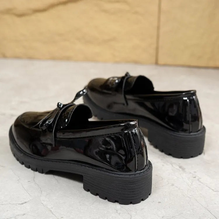 Women's brown and black loafers with bow detail on artificial PU upper, showing slip-on design