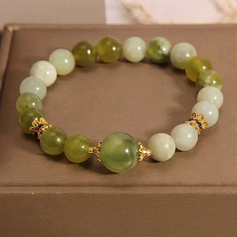 Xiuyan jade green Mori-style women's bracelet on a wrist.