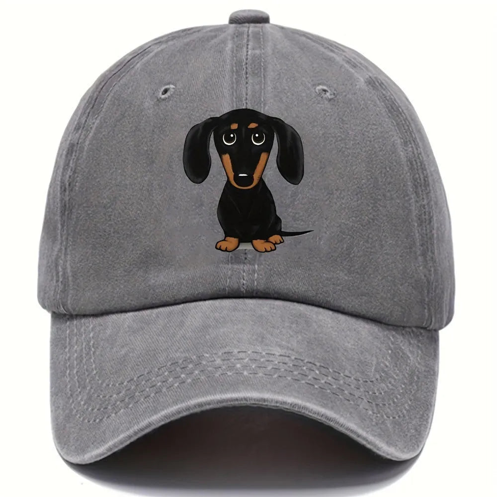Retro washed blue cotton baseball cap with a printed dachshund design on the front and a peaked brim.