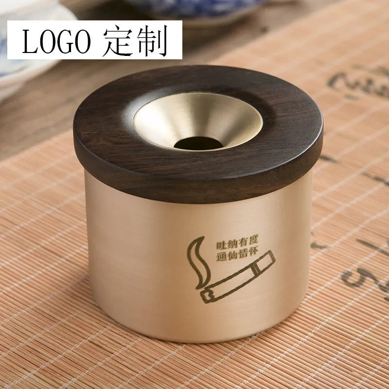 Brass ashtray with wooden lid showing central hole design for ash collection