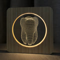 Tooth shaped wooden colour acrylic night lamp with USB cable on a table